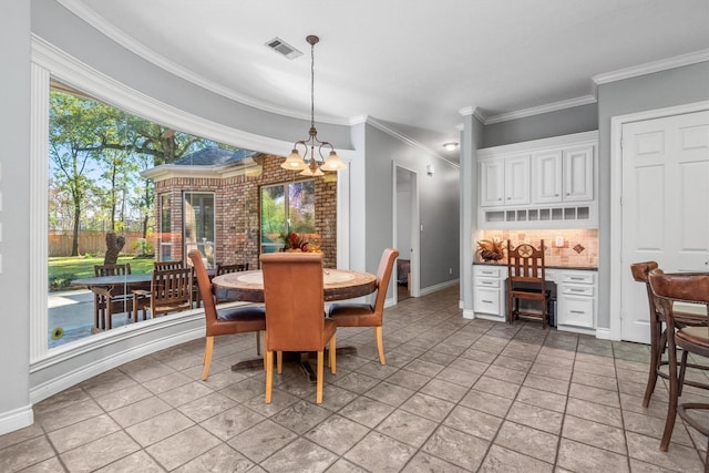 tiled dining space with crown molding and a notable chandelier