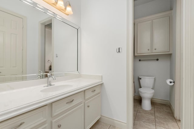 bathroom featuring tile patterned floors, vanity, and toilet