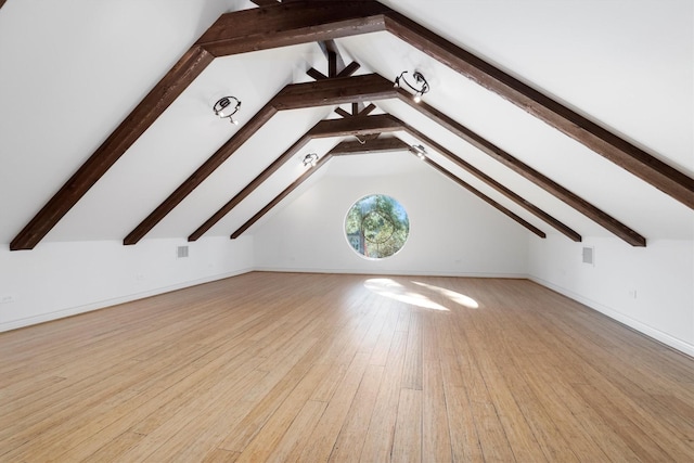 additional living space with light hardwood / wood-style floors and vaulted ceiling