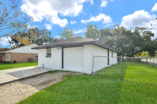 garage featuring a lawn