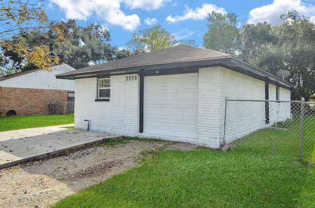 garage featuring a lawn