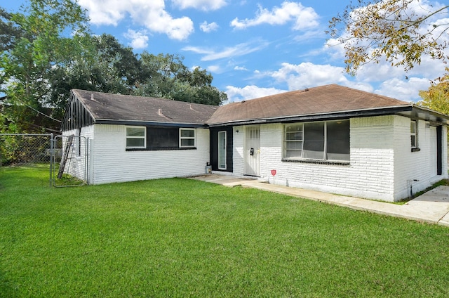 ranch-style home with a front lawn