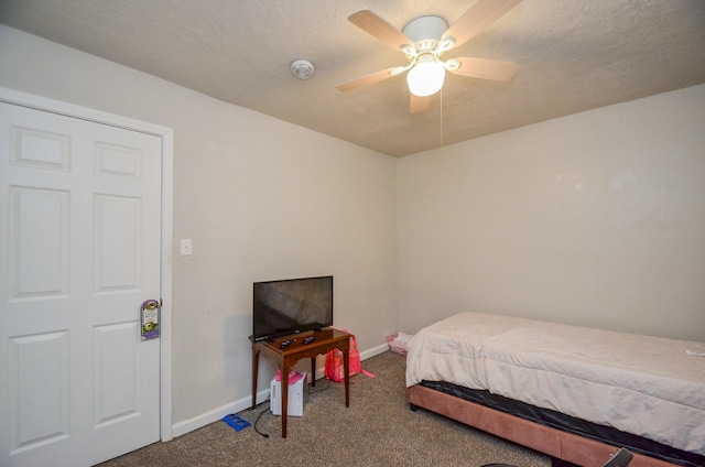 carpeted bedroom featuring a textured ceiling and ceiling fan