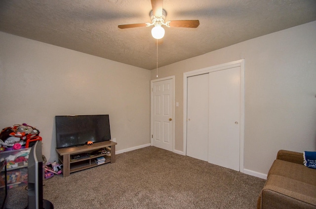 interior space featuring carpet flooring, ceiling fan, and a textured ceiling