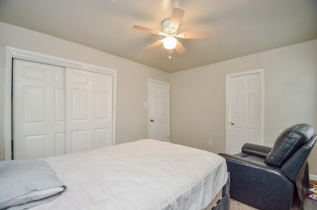 carpeted bedroom with a closet and ceiling fan