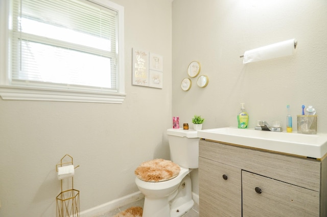 bathroom featuring vanity and toilet