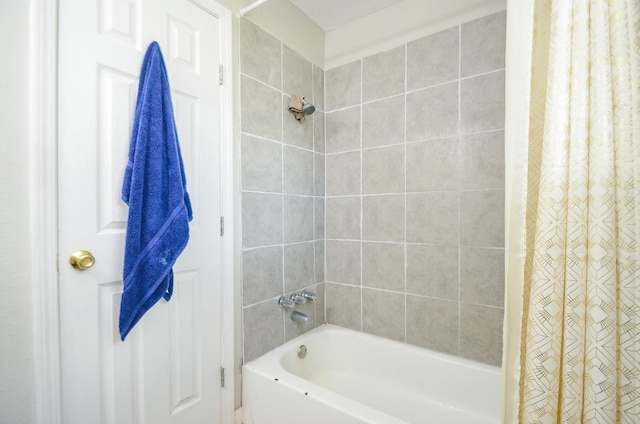 bathroom with shower / bath combo with shower curtain