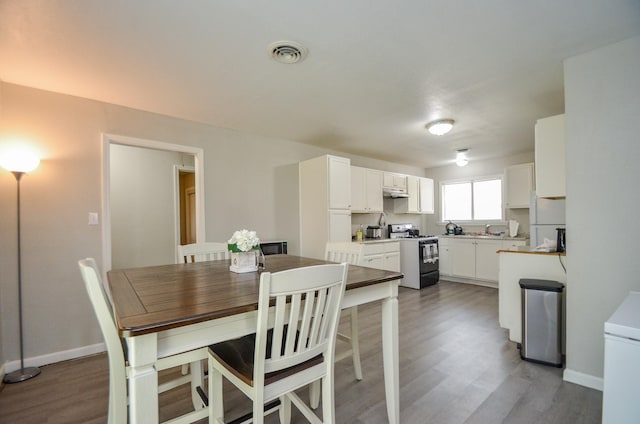 dining space featuring dark wood-type flooring