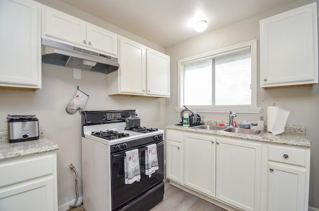 kitchen featuring white cabinets, light hardwood / wood-style flooring, white range with gas cooktop, and sink