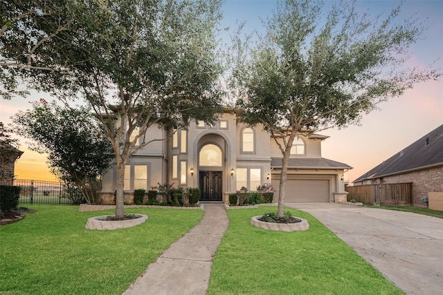 view of front of home featuring a lawn and a garage