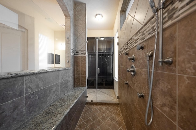 bathroom featuring tiled shower and tile patterned floors