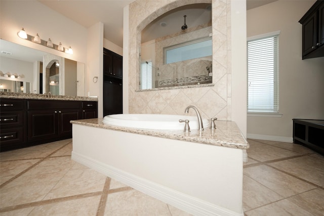 bathroom with tile patterned floors, vanity, and separate shower and tub