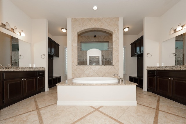 bathroom featuring tile patterned floors, vanity, and shower with separate bathtub