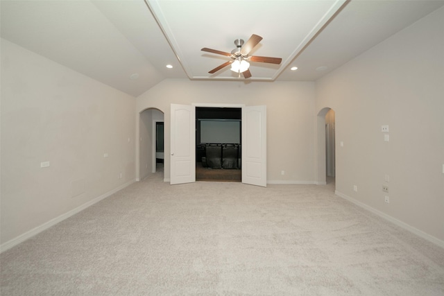 unfurnished bedroom featuring ceiling fan, light carpet, and vaulted ceiling