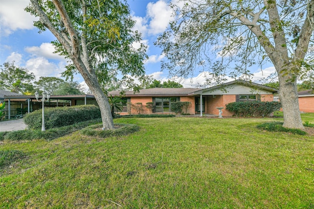 ranch-style home featuring a front yard