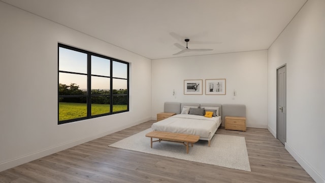 bedroom featuring light wood-style floors, baseboards, and a ceiling fan