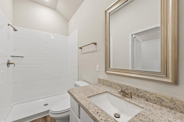 bathroom featuring walk in shower, vanity, vaulted ceiling, wood-type flooring, and toilet