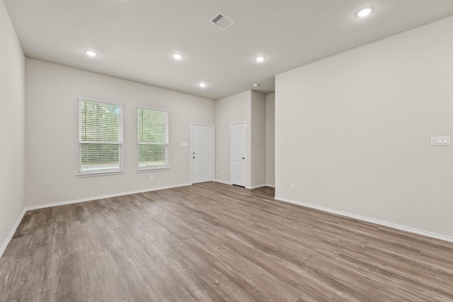 spare room with light hardwood / wood-style flooring