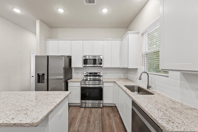 kitchen featuring white cabinets, sink, stainless steel appliances, and dark wood-type flooring