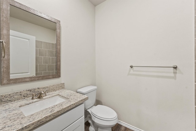 bathroom featuring hardwood / wood-style flooring, vanity, and toilet