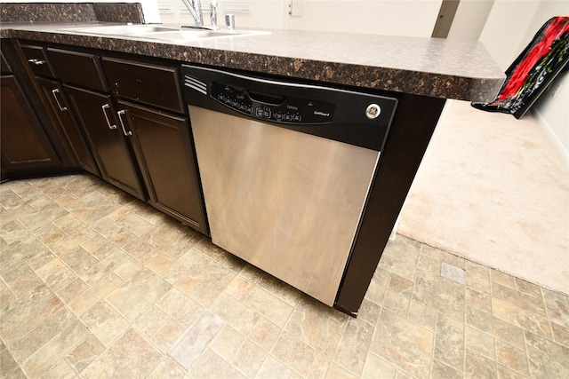 kitchen featuring light carpet, kitchen peninsula, stainless steel dishwasher, dark brown cabinetry, and sink