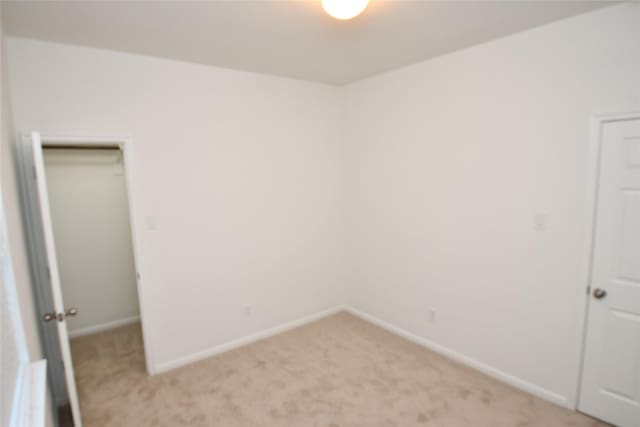 spare room with light colored carpet