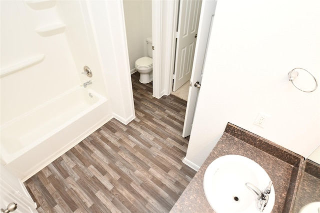 full bathroom featuring wood-type flooring, vanity, toilet, and shower / bathtub combination