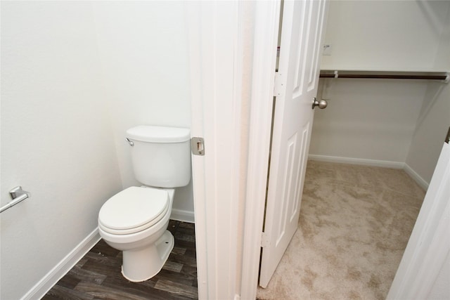 bathroom with toilet and wood-type flooring