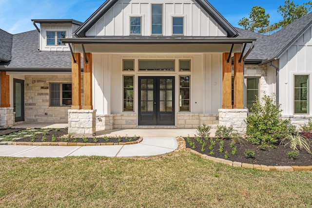 doorway to property featuring a lawn and french doors