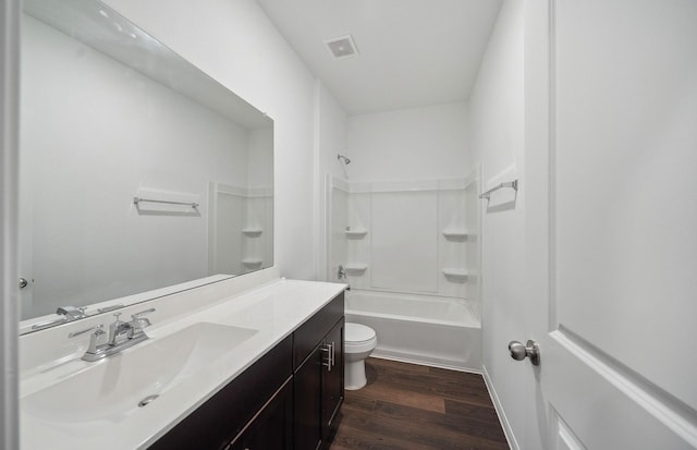 full bath with visible vents, toilet, wood finished floors, shower / bath combination, and vanity