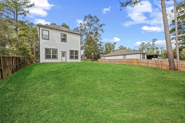 rear view of house with a yard