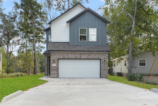 front of property with a garage, central air condition unit, and a front lawn