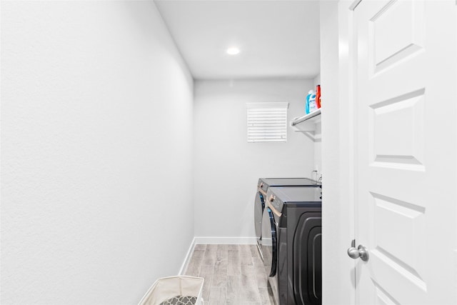 washroom featuring light wood-type flooring and washing machine and clothes dryer