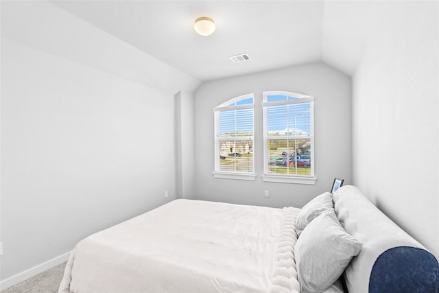 carpeted bedroom featuring lofted ceiling