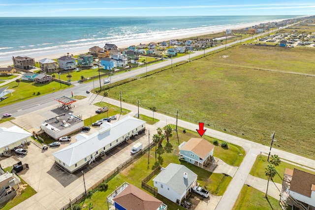 bird's eye view with a water view and a beach view