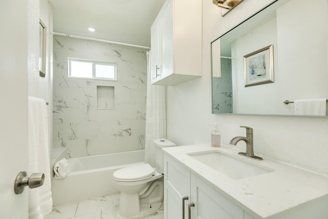 full bathroom featuring tiled shower / bath, vanity, and toilet