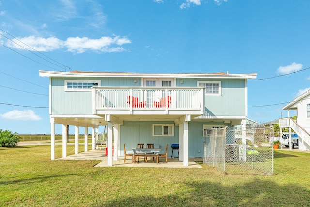 back of property featuring a patio and a lawn