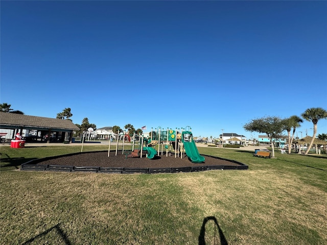 view of jungle gym featuring a lawn