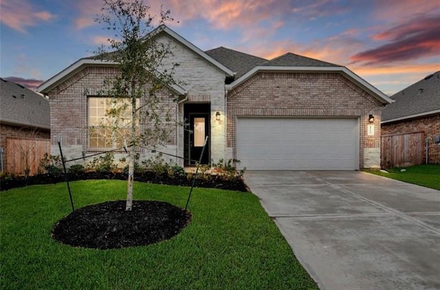 view of front facade featuring a yard and a garage