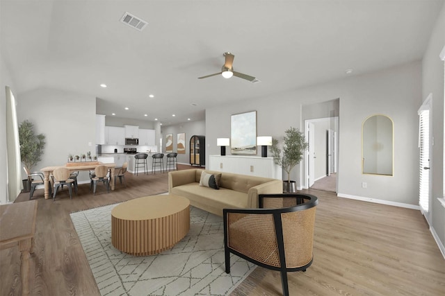 living room featuring ceiling fan and light wood-type flooring