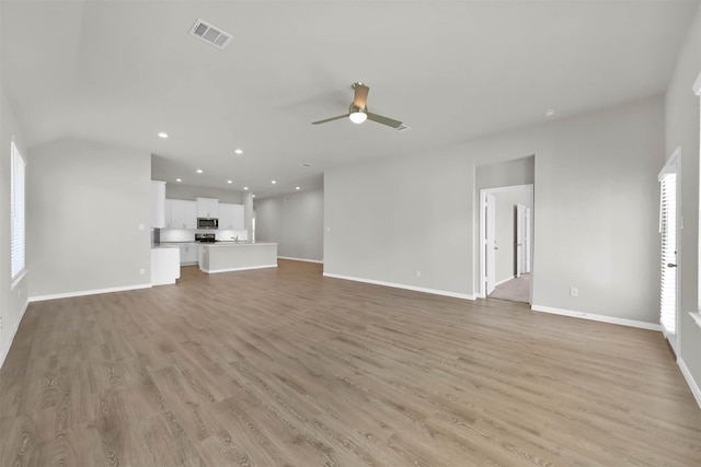 unfurnished living room with ceiling fan and light wood-type flooring