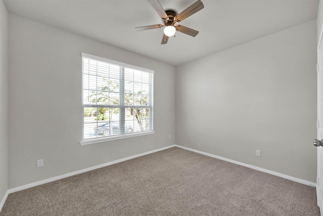 carpeted empty room featuring ceiling fan