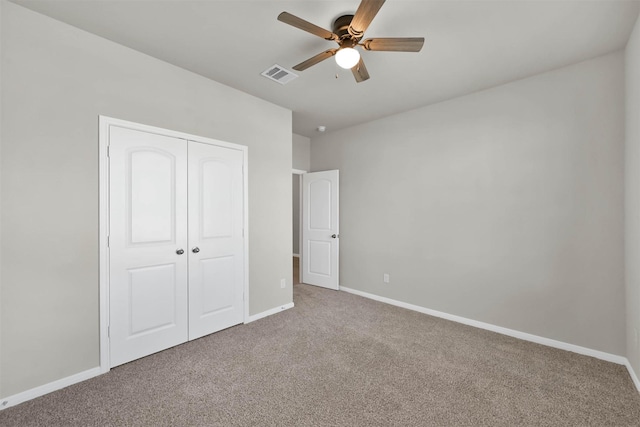 unfurnished bedroom featuring ceiling fan, carpet floors, and a closet