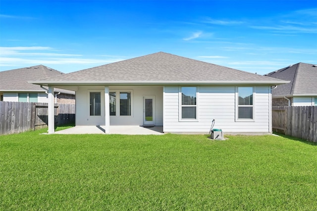 back of property featuring a lawn and a patio area