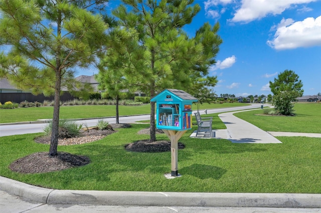 view of community with a lawn and a playground