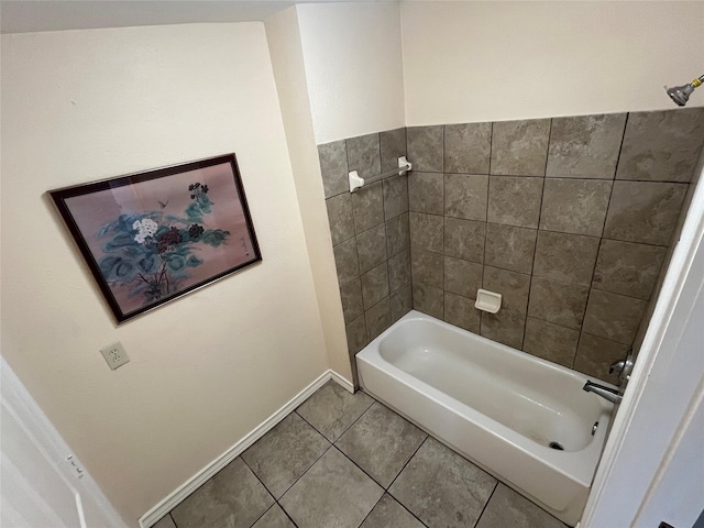 bathroom featuring tile patterned flooring and tiled shower / bath