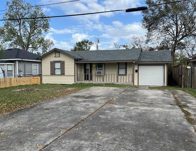 ranch-style home with cooling unit, covered porch, and a garage