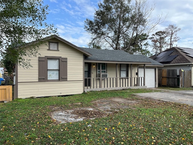 view of front of property featuring covered porch, a garage, and a front yard