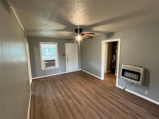 unfurnished living room featuring a textured ceiling, ceiling fan, dark wood-type flooring, and heating unit