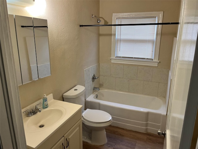 full bathroom featuring hardwood / wood-style floors, vanity, shower / bath combination, and toilet